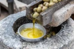 olive-oil-extraction-process-traditional-stone-mill-local-farm-workers-extracting-using-early-morning-fresh-390985956.jpg