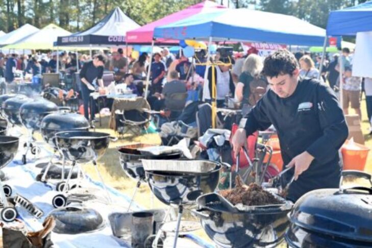 A pit master tends the grills at a past Festival. (2023 Festival photo)